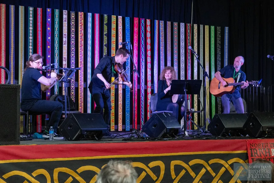 A Celtic folk band performing on stage at the North Texas Irish Festival.