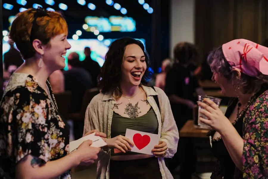 People laughing as they read their ice breaker cards.