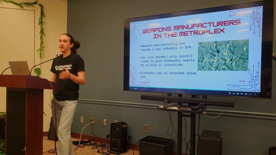 DSA Member stands in front of a podium, a slide describes AI Powered Drone Weapons