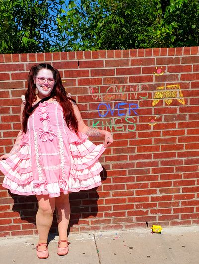 Tepani the clown curtseying next to her 'graffiti'