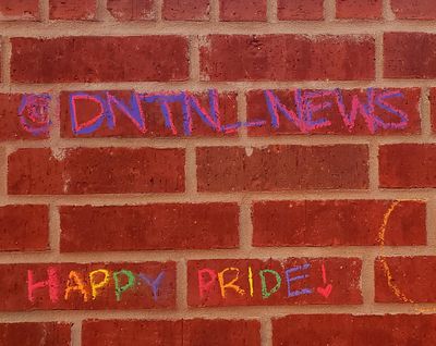 DNTN's logo written in chalk on the wall.