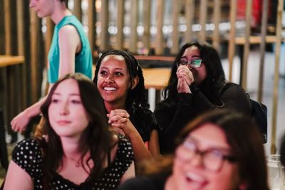 Audience members smiling.